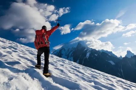 A solo traveler walking across the glacier, immersed in the raw, untouched beauty of nature's frozen giants.