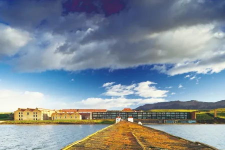 The hotel's iconic dock and elegant façade welcome visitors with charm.