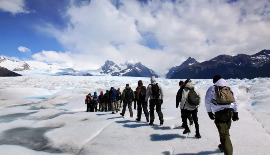 Gruppo di escursionisti con gli zaini che camminano sul ghiaccio del ghiacciaio Perito Moreno, El Calafate, Patagonia, Argentina